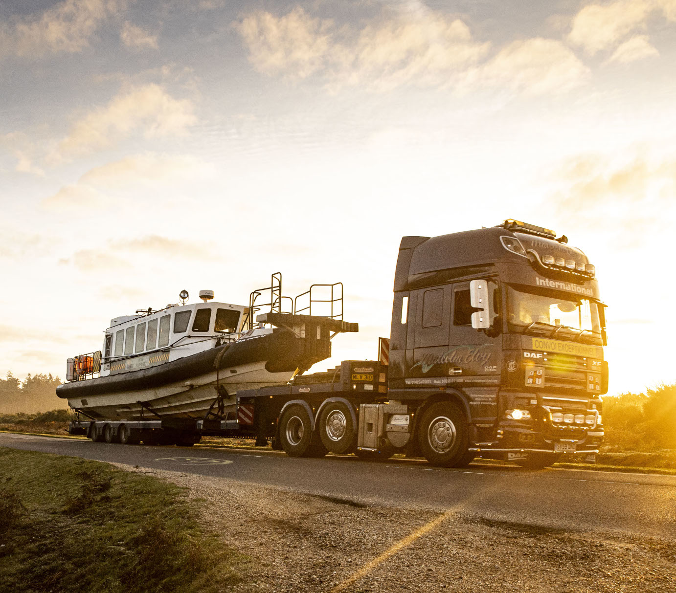 Commercial RIB transported by articulated low loader for vessel logistics operation