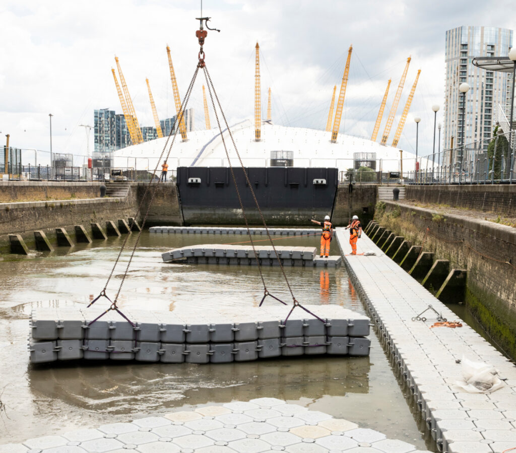 Marine construction works using temporary floating pontoons and access walkways during dockside operations in the UK