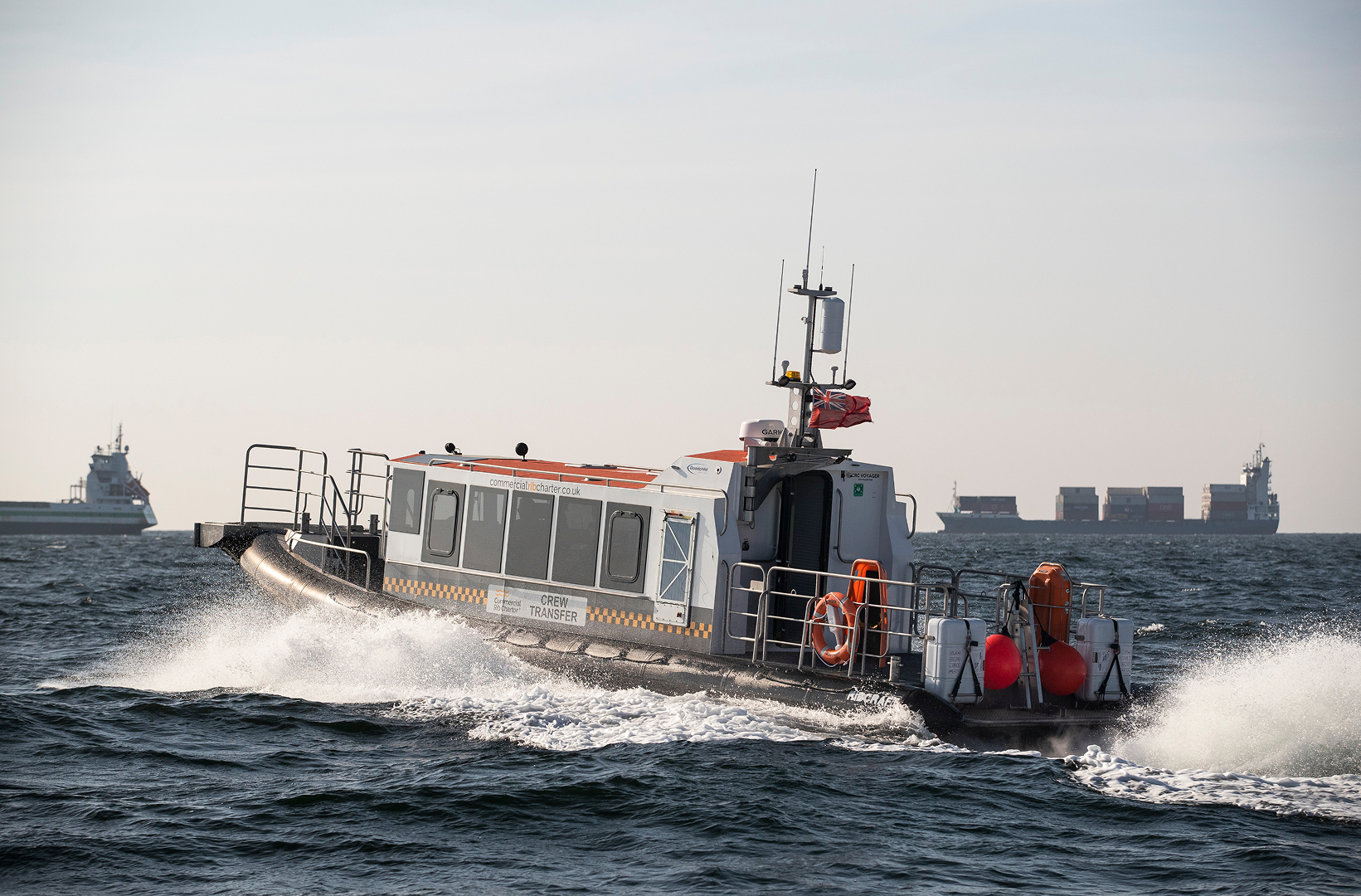 Commercial RIB crew transfer vessel operating offshore in open sea conditions.