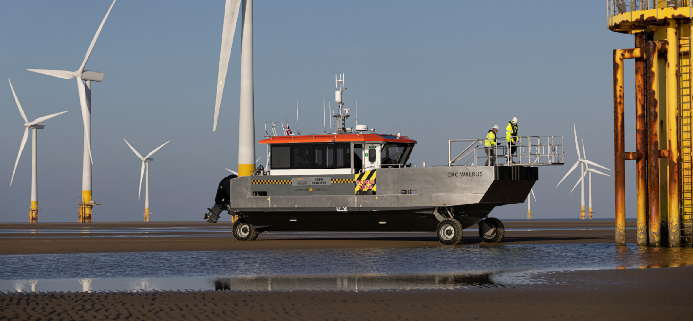Amphibious commercial RIB crew transfer vessel operating at an offshore wind farm, providing all-weather marine logistics and offshore support services in the UK.