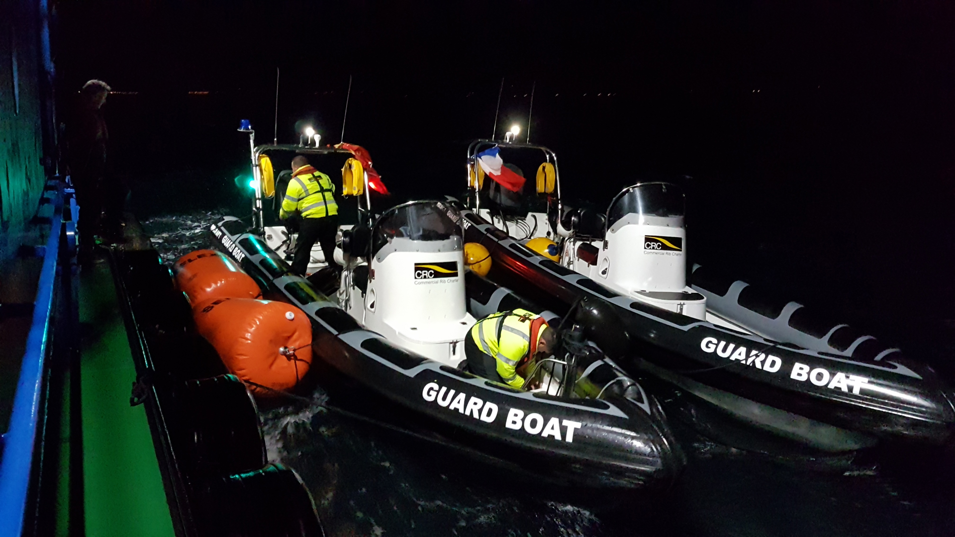 Commercial RIB guard boats operating at night alongside offshore marine works, providing safety cover, standby rescue, and vessel support in UK waters.
