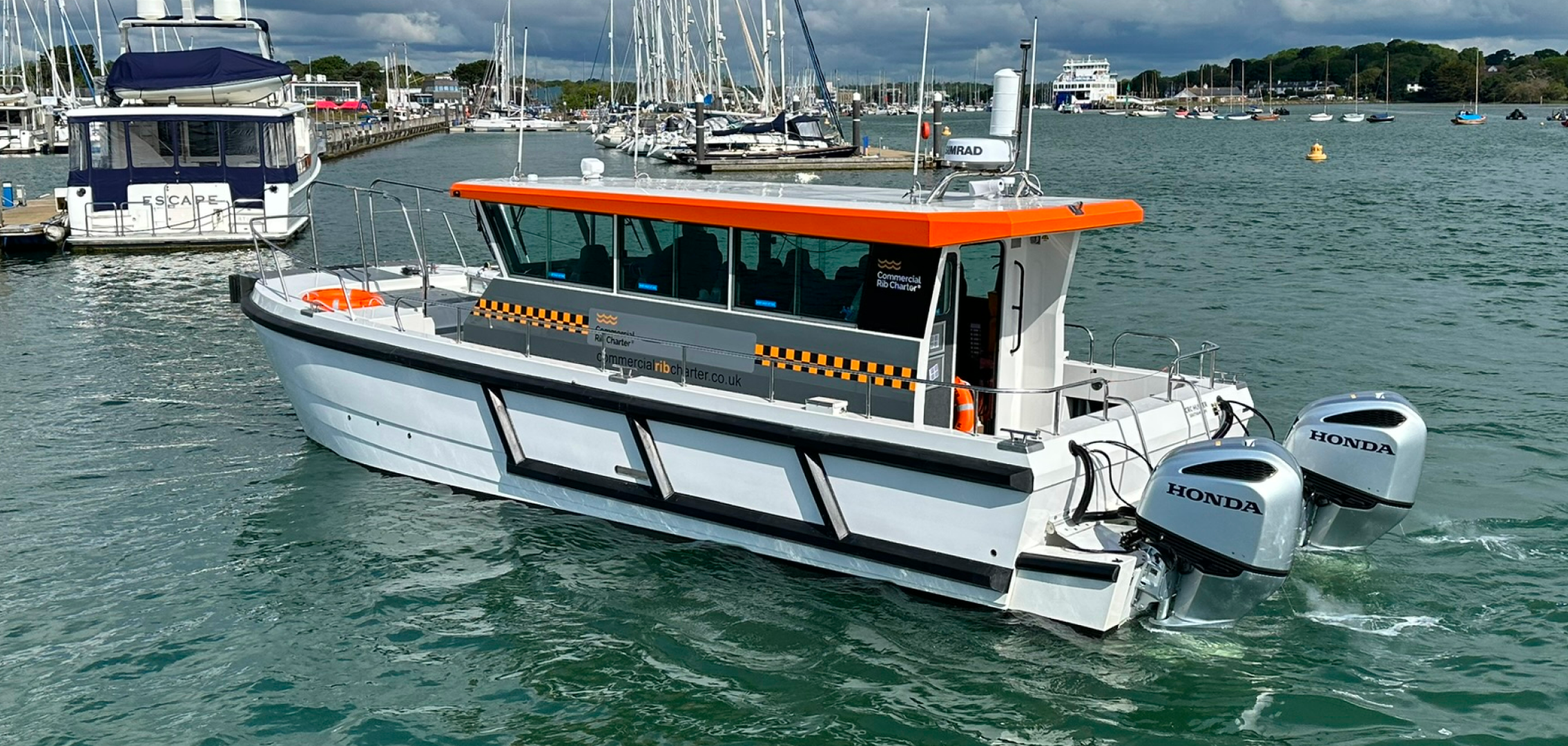 Rear view of CRC Hunter commercial catamaran workboat underway with twin outboard engines
