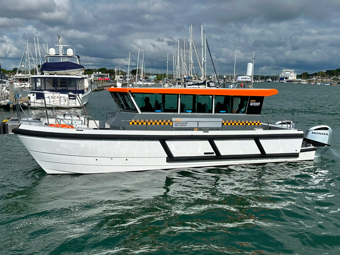 Side view of CRC Hunter commercial catamaran workboat underway in a marina